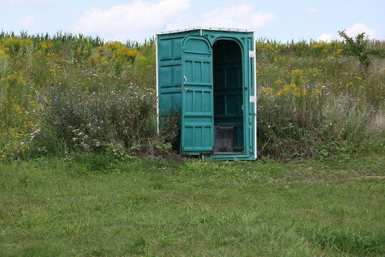 Portable toilet cabin in a natural outdoor setting