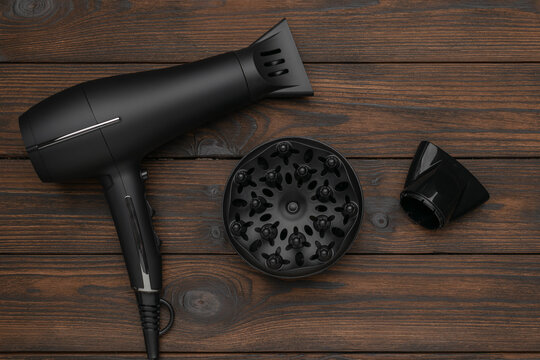 Professional Black Hair Dryer Set on Wooden Background with Attachments