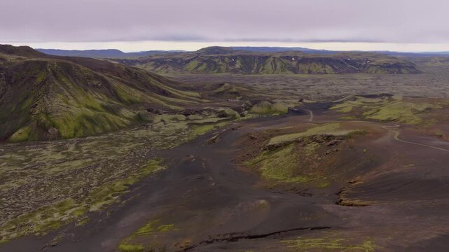 Aerial view of glacial river valley with moss-covered lava fields, Iceland  