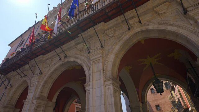 Low angle view of the historic city hall balcony and arches at Plaza Mayor in Cuenca Spain