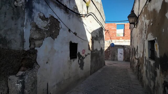 Dilapidated historic buildings in narrow alley of San Mateo, Jerez de la Frontera