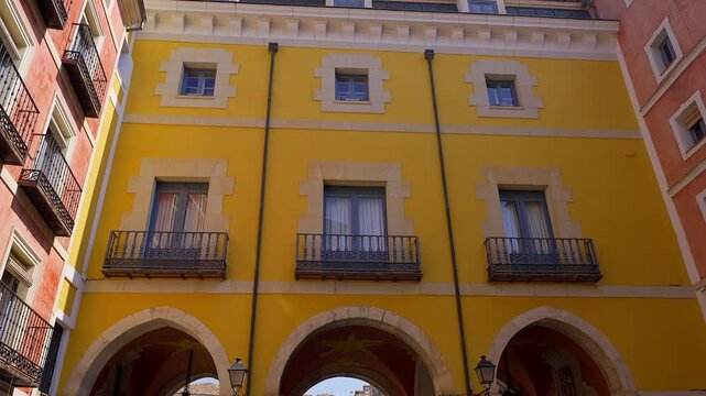 Yellow arcaded facade at Plaza Mayor in the historic center of Cuenca Castilla La Mancha