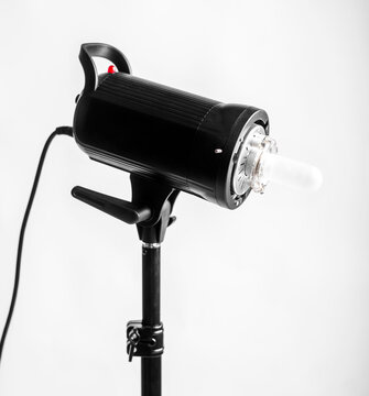 Professional photo studio strobe light with reflector isolated on white background