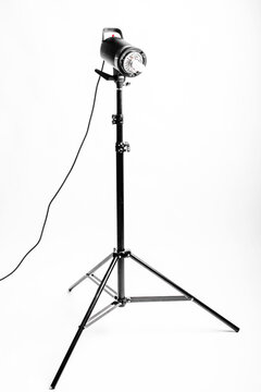 Professional photo studio strobe light with reflector isolated on white background