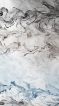 Abstract black and blue smoke plumes swirling and dispersing elegantly against a plain white background.