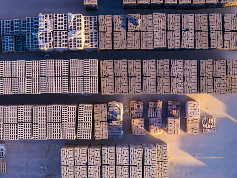 Aerial view of stacks of architectural blocks including bricks, pavers, and cinder blocks arranged in rows for construction and landscaping in Bluffdale, Utah, United States.