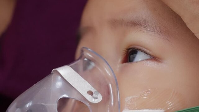 Baby boy receives respiratory therapy with a nebulizer mask during hospital care for a lung infection, showing pediatric treatment, breathing support, medication, and recovery.