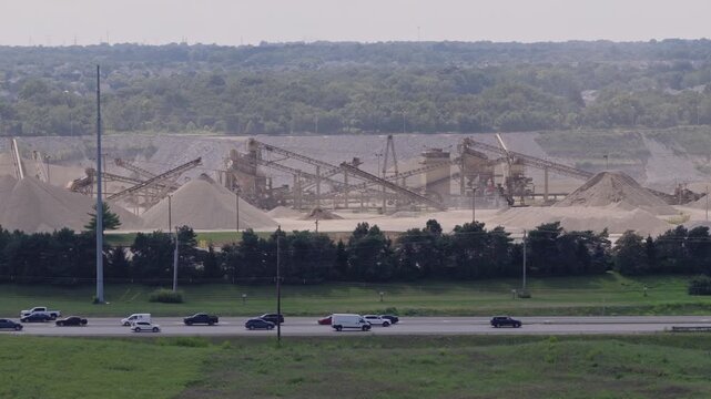 Drone aerial of huge mineral plant and mine along interstate 71 i71 road and highway, as industrial mining of gravel, limestone, sand, and other minerals are mined from Ohio equipment by Columbus, OH