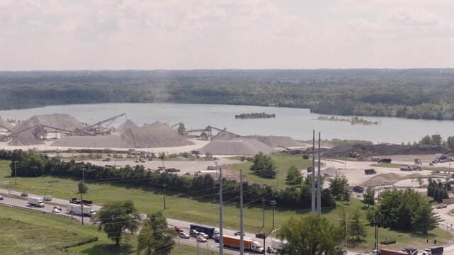 Drone aerial of huge mineral plant and mine along interstate 71 i71 road and highway, as industrial mining of gravel, limestone, sand, and other minerals are mined from Ohio equipment by Columbus, OH