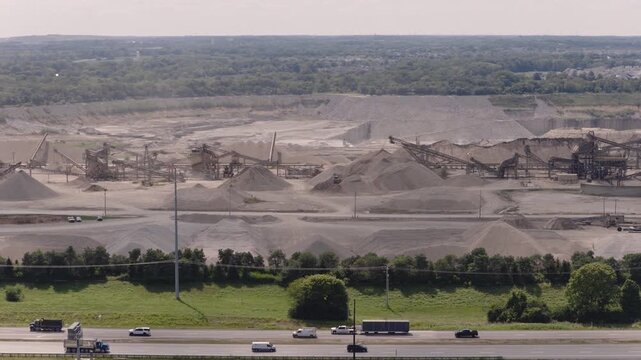 Drone aerial of huge mineral plant and mine along interstate 71 i71 road and highway, as industrial mining of gravel, limestone, sand, and other minerals are mined from Ohio equipment by Columbus, OH