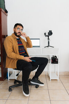 Portrait of a photographer looking at the camera.