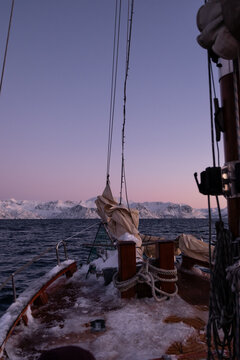 Views of snowy mountain peaks in Norway on board a boat in the arctic 