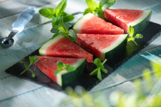 Watermelon slices with mint on slate board