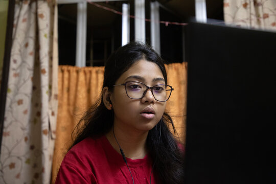 Young Indian woman doing study inside home