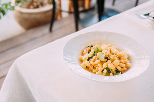 Pasta dish served on a white tablecloth at a dining location