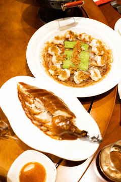 Seafood dishes served at a dining table in a restaurant