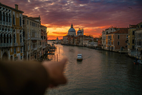 Pointing at Grand Canal Sunrise from Accademia Bridge in Venice