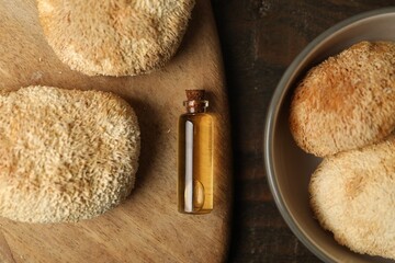 Functional mushrooms and oil on wooden table, flat lay © New Africa