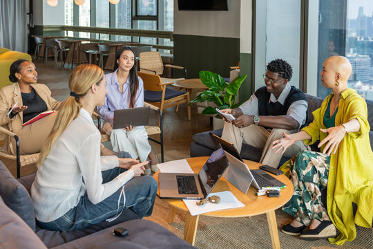 Group of People in a Meeting While Discussing Ideas in an Office