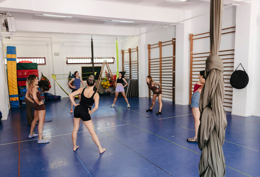 Group of women warming up for aerial fitness class