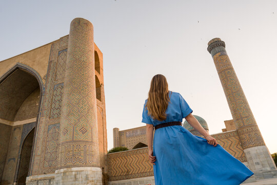 Woman Standing Near Historical Building In Uzbekistan