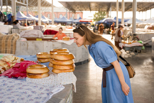 Woman Smelling Fresh Bread at Siyob Market in Samarkand