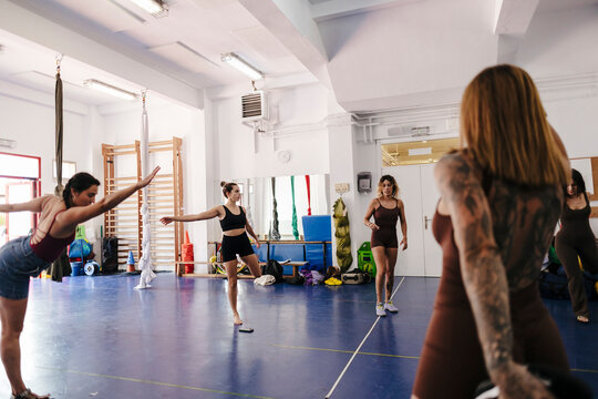 Women practicing balance and movement in a dance studio