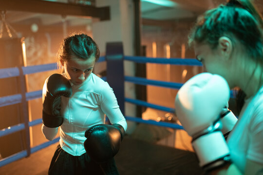 Woman boxer with opponent in boxing ring during the fight