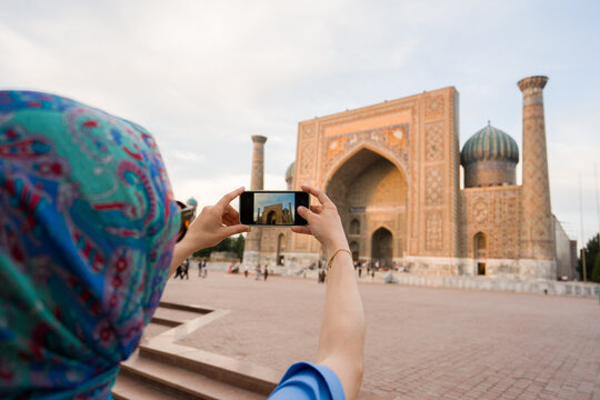 Woman Taking Photo Using Phone In Registan Square, Samarkand