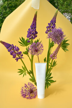 Blank Cosmetic Tube With Purple Wildflowers on Yellow Background