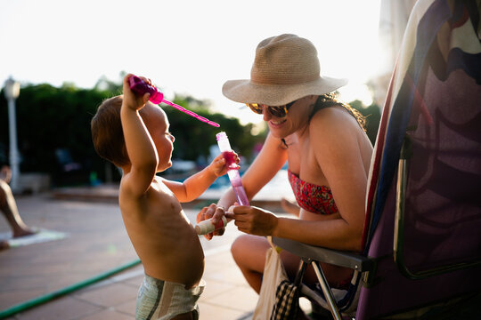 Mother and son playing with bubbles outdoors