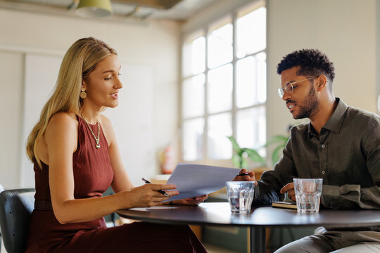 Professionals discussing business documents during a meeting