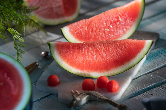 Watermelon slices and scooped balls on marble board
