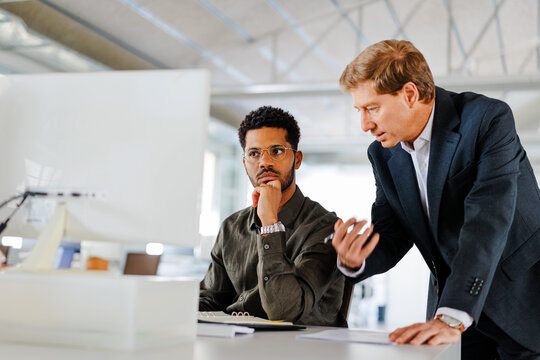 Business professionals working on computer in office