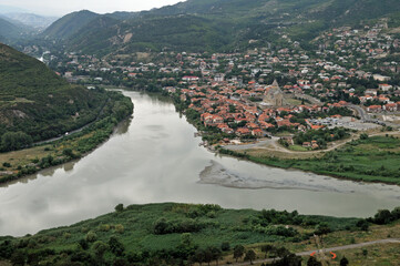 Panoramic view of the confluence of Mtkvari (Kura) and Aragvi rivers with the ancient town of Mtskheta and Svetitskhoveli Cathedral in Georgia © MikhailT