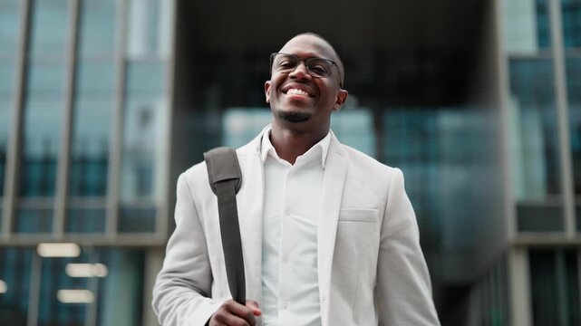 CEO, african american businessman, confident portrait, outdoor near office building. Black business man smiling, works as CEO, building strong client partnerships, leading cross-functional projects.
