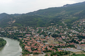 Aerial view of Mtskheta town and Svetitskhoveli Cathedral along the Mtkvari River in Georgia © MikhailT