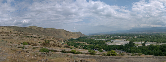 Wide panoramic view of Mtkvari River valley and rocky hills from Uplistsikhe ancient complex in Georgia © MikhailT