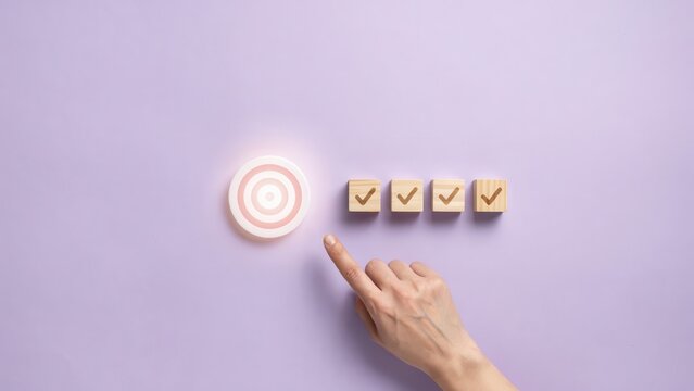 Reaching Goals A Hand Points to a Target with Checked Boxes Symbolizing Success and Completion