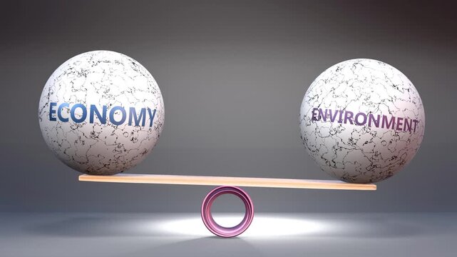 Economy and environment in balance - balancing stones on a scale symbolizing harmony, equity and equilibrium between economy and environment. Harmonious and beneficial situation.