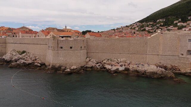 Dubrovnik seaward city walls and breakwater on the rocky coast