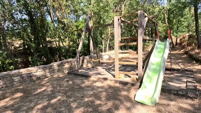 Empty Children's Playground in Deserted Rural Village During Extreme Heatwave, Occitanie, France