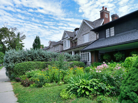 Residential street with traditional detached houses and front garden
