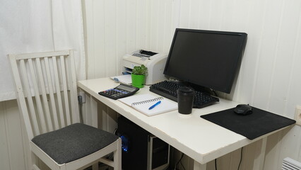 Fototapeta premium Modern workspace for freelance or remote study. Monitor, calculator, notebook, documents on white desk. Home Office Setup, Remote Accounting. Freelance Freedom. Student Workspace, Distance Learning.