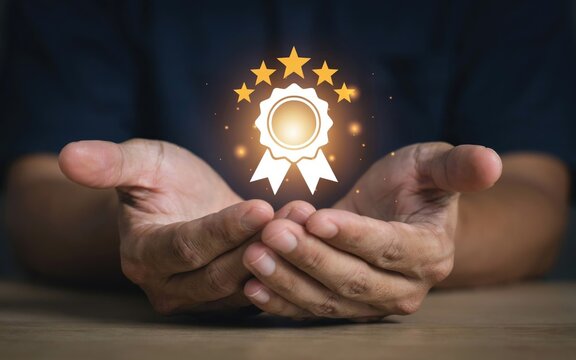 Hands cupping a glowing five-star badge holding five stars