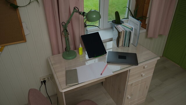 Remote workplace of accountant, bookkeeper. No people. Work place in a kitchen. Working from home. Business report, data entry for company tasks. Laptop, calculator and paperwork. Study, productivity