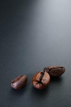 Roasted coffee beans on black background with copy space