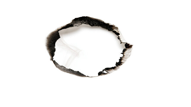 Rough burnt hole with black charred edges, isolated on transparent background