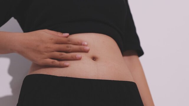 Pregnant woman pregnancy concept heart on stomach. Hands forming heart on female belly button. Healthy stomach health concept, or early pregnancy concept with beautiful female hands. Woman model.