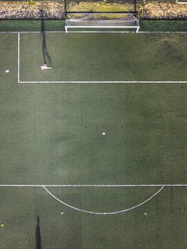 Aerial view of a football field with green turf, white boundary lines, and a goal post in Lisbon, Lisbon, Portugal.
